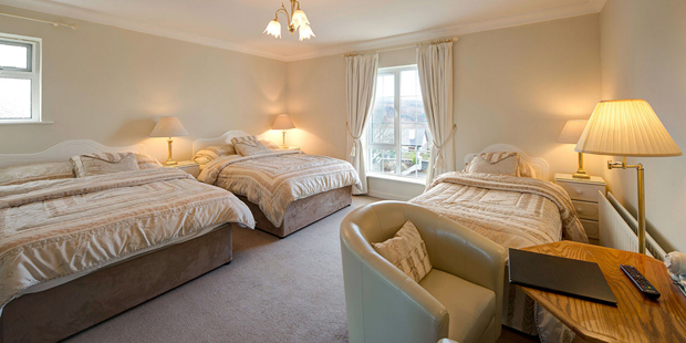 Family Room - A room with one double bed and two single beds or two double beds, suitable for a family of four.